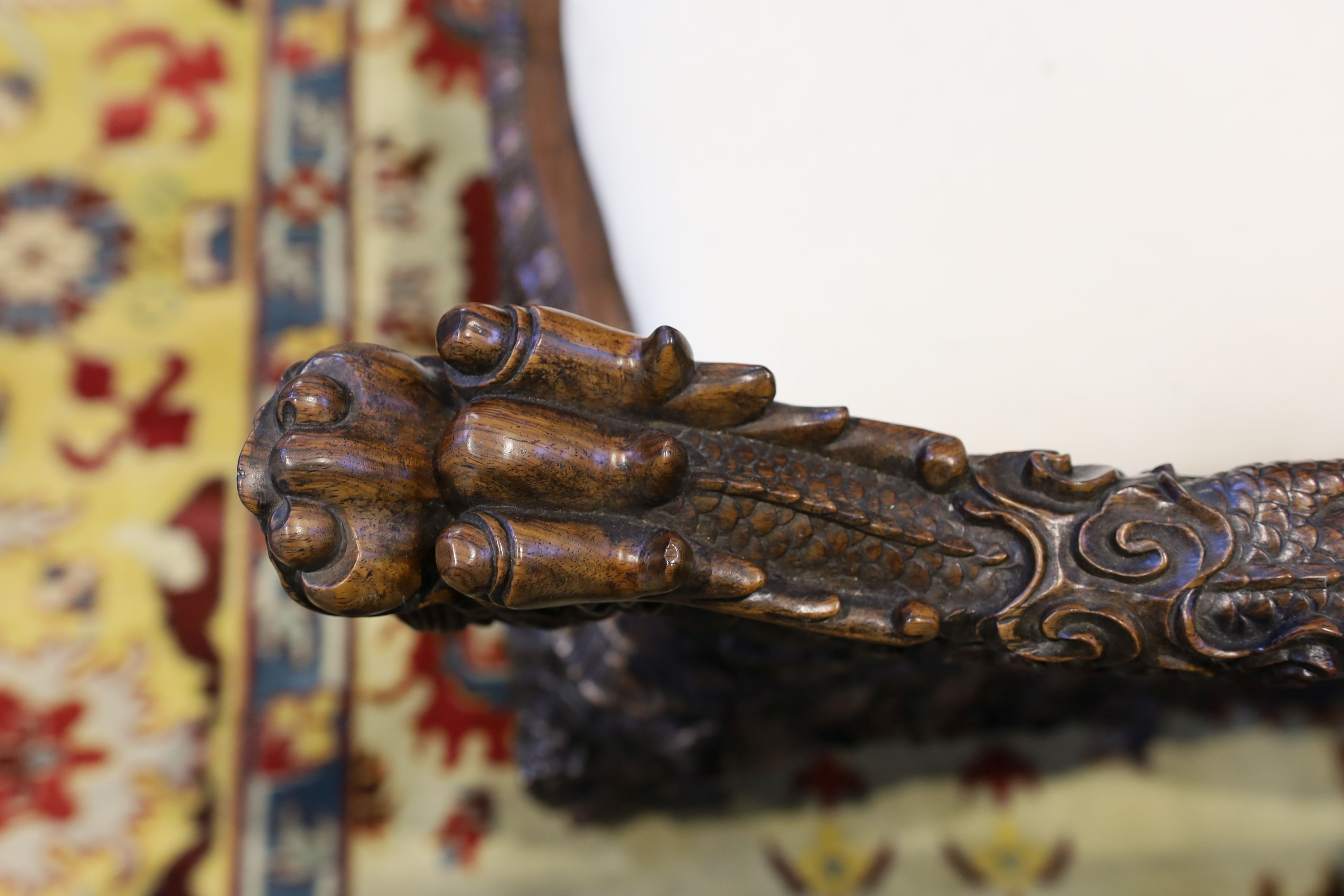 A good Chinese hardwood ‘dragon’ throne armchair, c.1900, 114.5cm high, 68cm wide at the arms